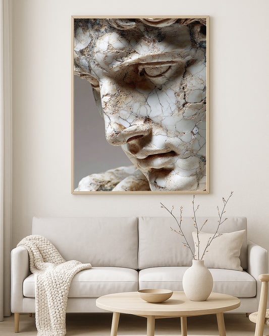 Classical statue face artwork showing a close-up cracked marble surface with aged neutral tones.