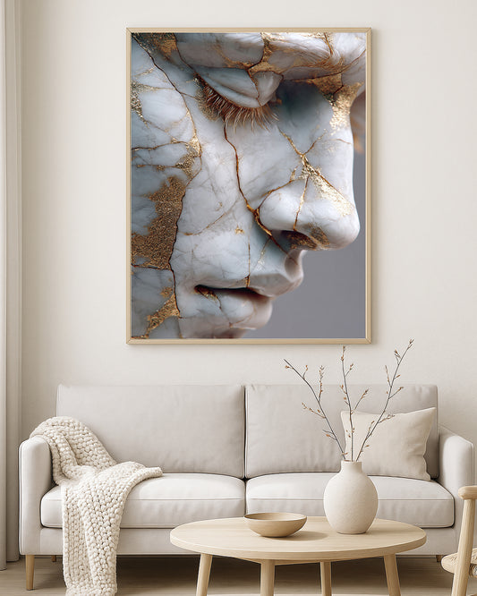 Sculptural portrait artwork showing a serene marble face profile with warm gold fissure accents.
