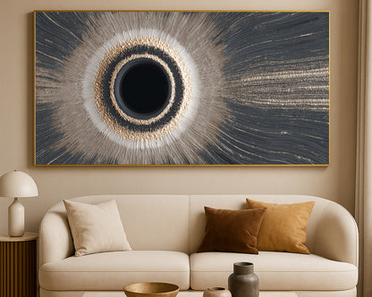 Modern wide abstract print with a black circular center, luminous halo, and sweeping linear textures in gray, cream, and gold