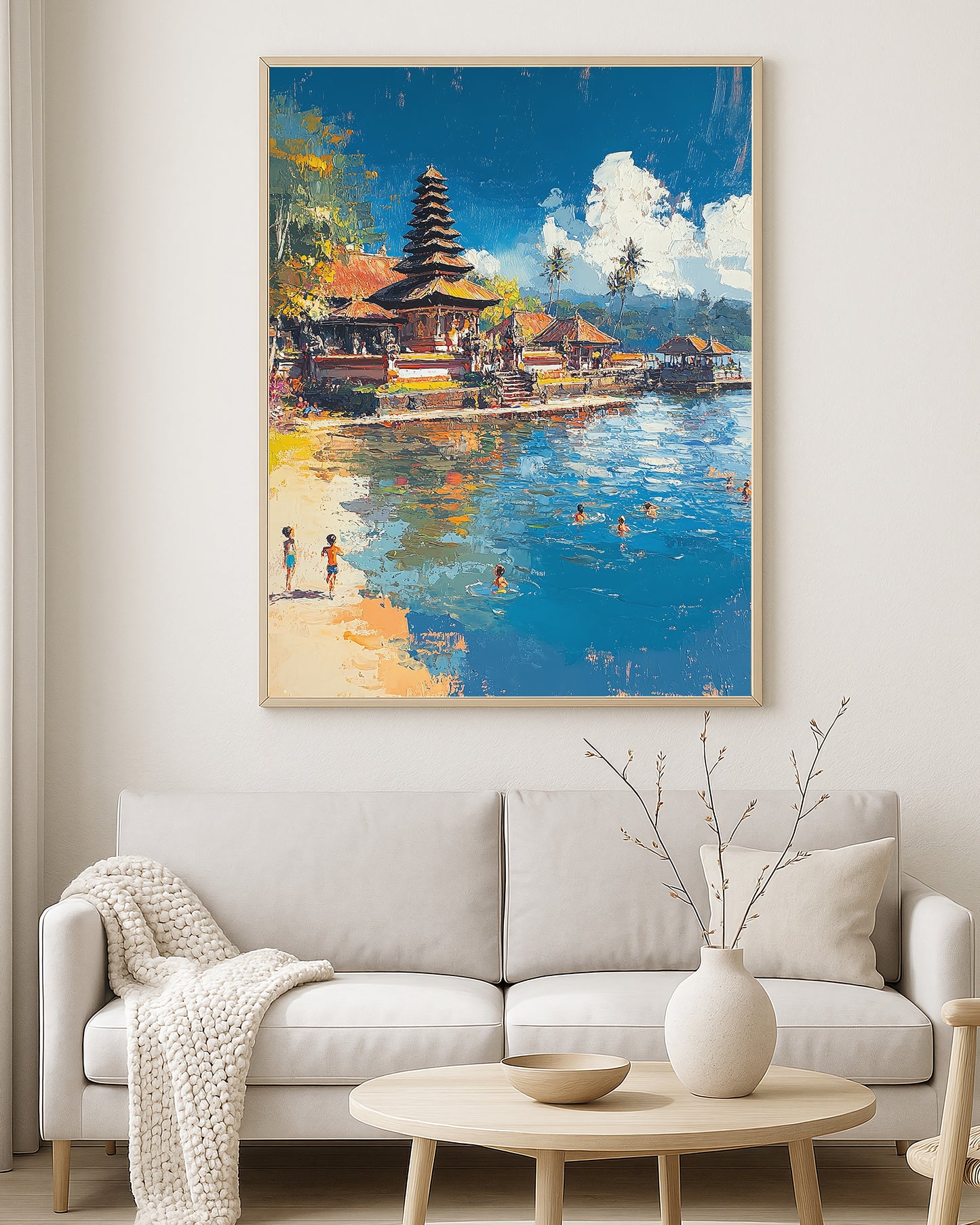 Tropical waterfront scene with a temple complex, sandy beach, calm blue sea, and small figures swimming near the coast.