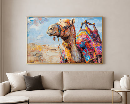 Textured animal painting of a camel in warm desert tones with a bright multicolored saddle and soft sandy backdrop.