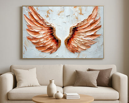 Elegant spiritual wall art showing a pair of peach and cream wings centered on a white textured surface.