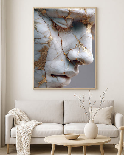 Sculptural portrait artwork showing a serene marble face profile with warm gold fissure accents.