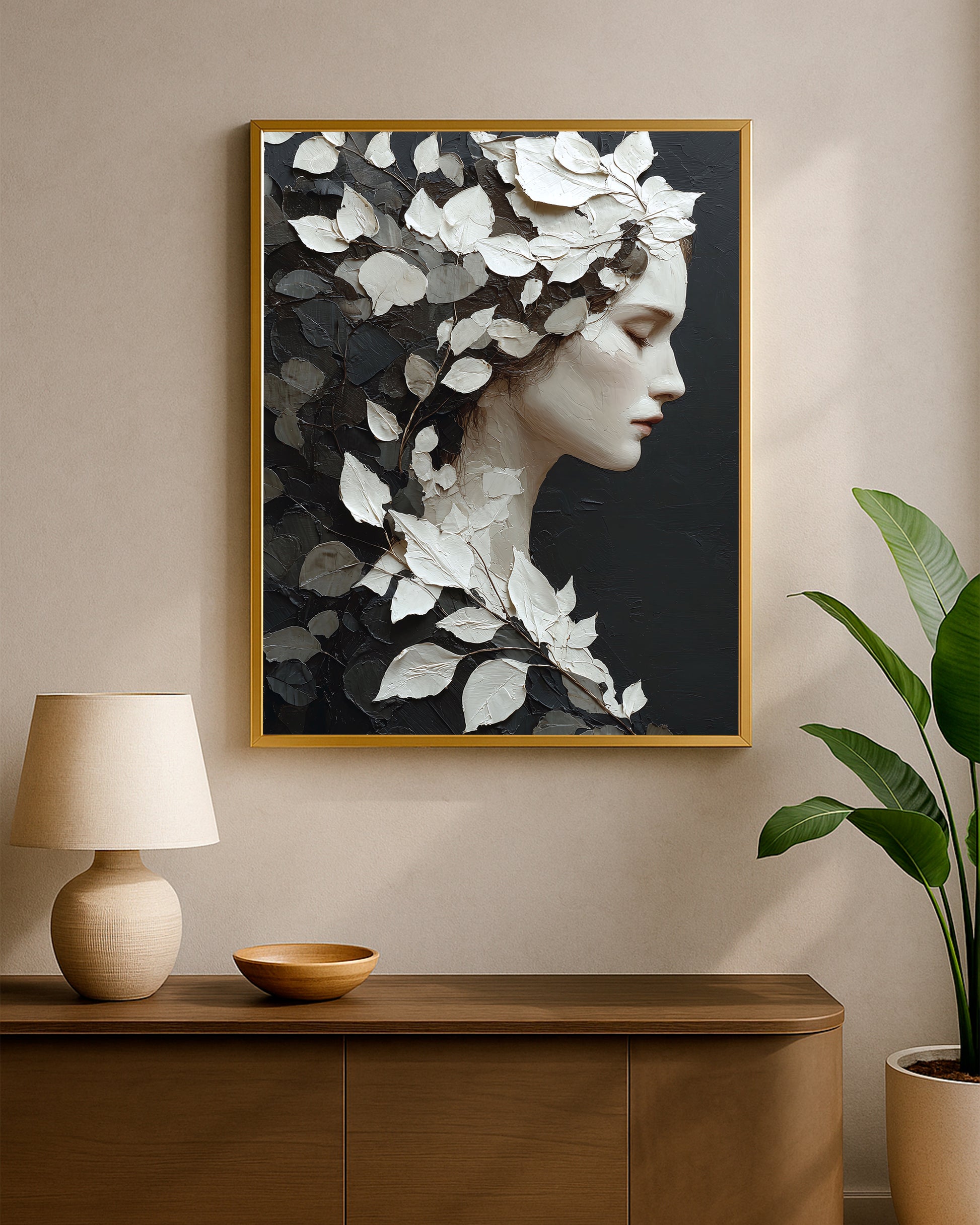 Fine art woman profile wall art featuring white leaves, black foliage, cream face detail, and textured surface.