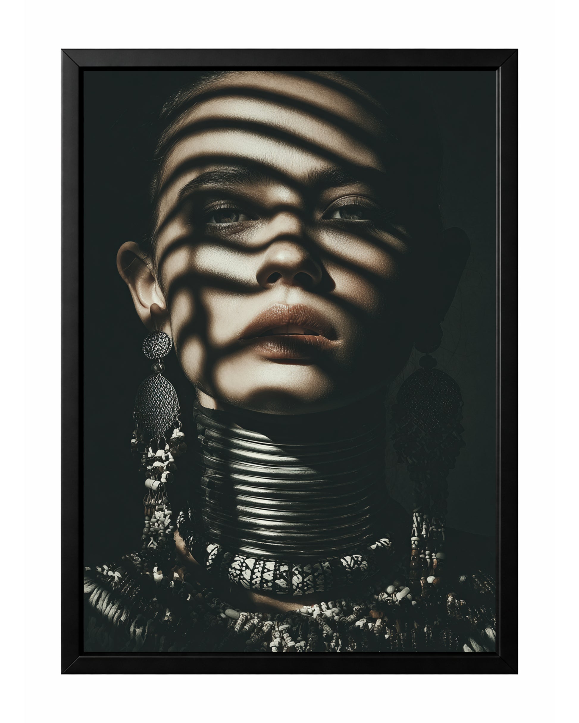 Moody woman portrait wall art with shadow bands across the face, ornate earrings, and layered neck jewelry.