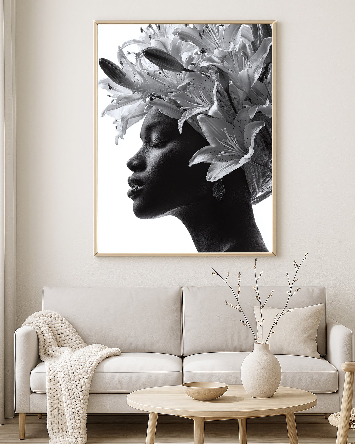 Monochrome portrait artwork of a woman with closed eyes surrounded by oversized lily flowers against a soft light background