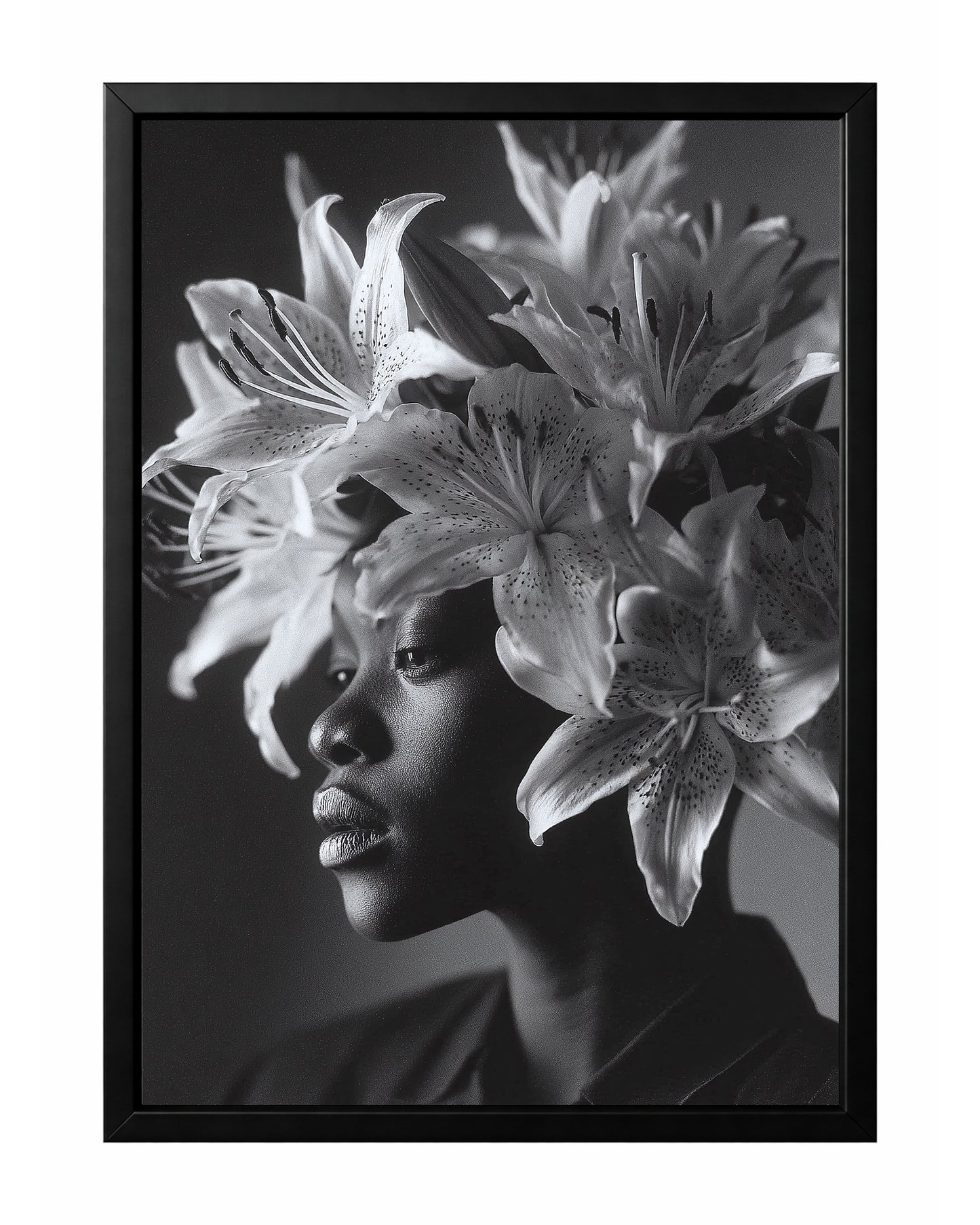 Black and white floral woman portrait wall art featuring a side profile framed by large blooming lilies and unopened buds