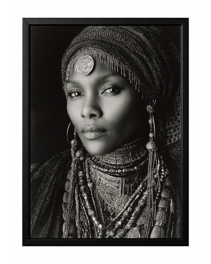 Monochrome African-inspired woman portrait with ornate head covering, layered jewelry, and direct gaze.