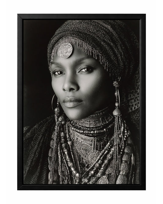 Monochrome African-inspired woman portrait with ornate head covering, layered jewelry, and direct gaze.